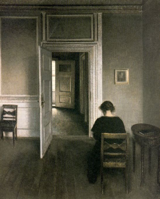 interior-with-woman-dressed-in-black-sitting-on-yellow-brown-chair-strandgade-1908